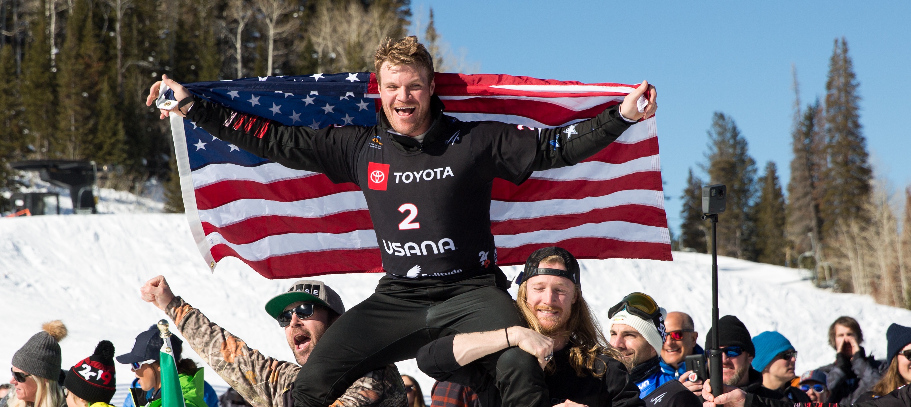 U.S. Snowboardcross Team members Nick Baumgartner and Hagen Kearney carrying Mick Dierdorff to the podium at the Pacifico SBX Finals at the 2019 FIS World Champs in Solitude, Utah. (U.S. Ski & Snowboard) Mick Hero
