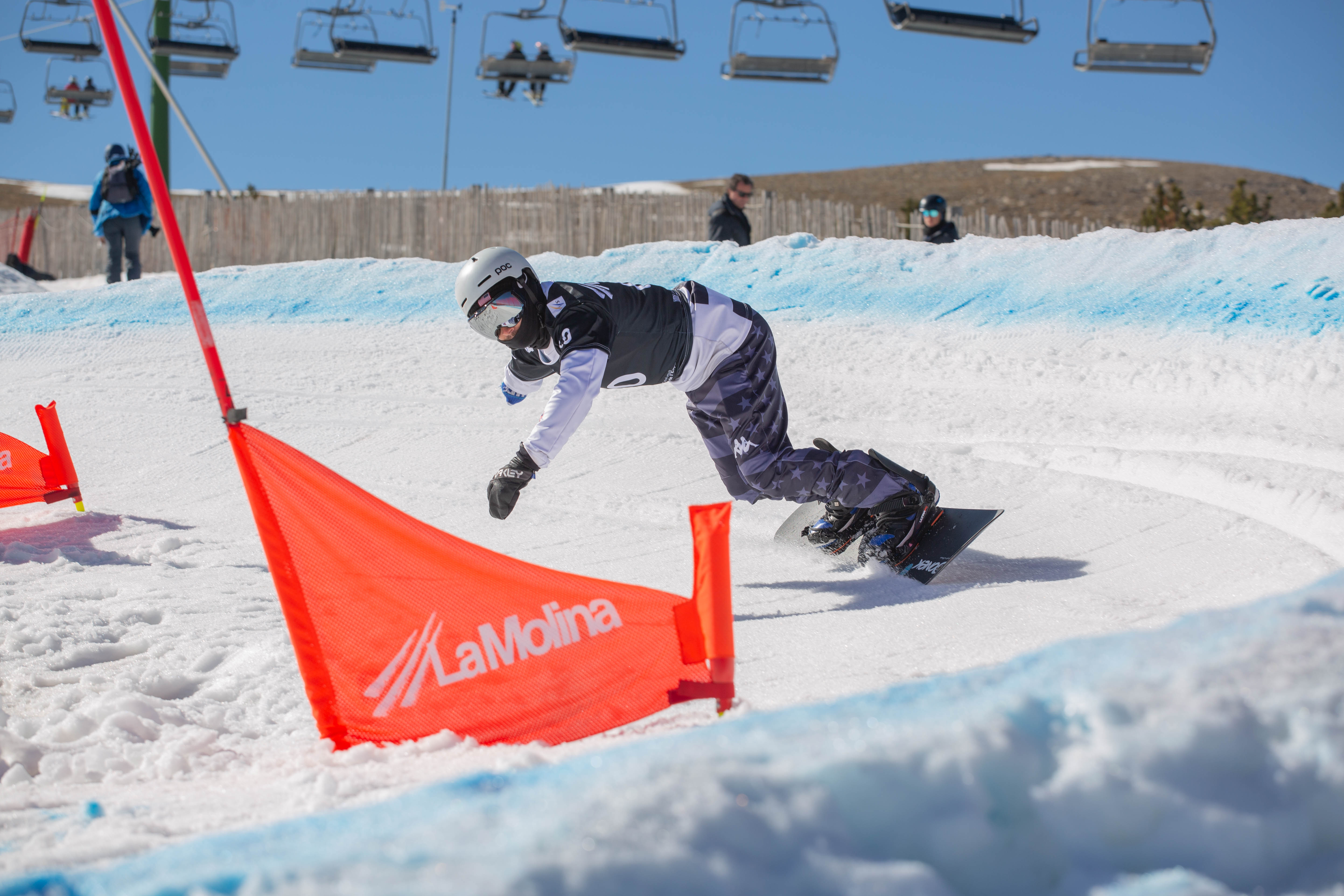 U.S. Para Snowboard athlete rounds a gate during a snowboardcross race