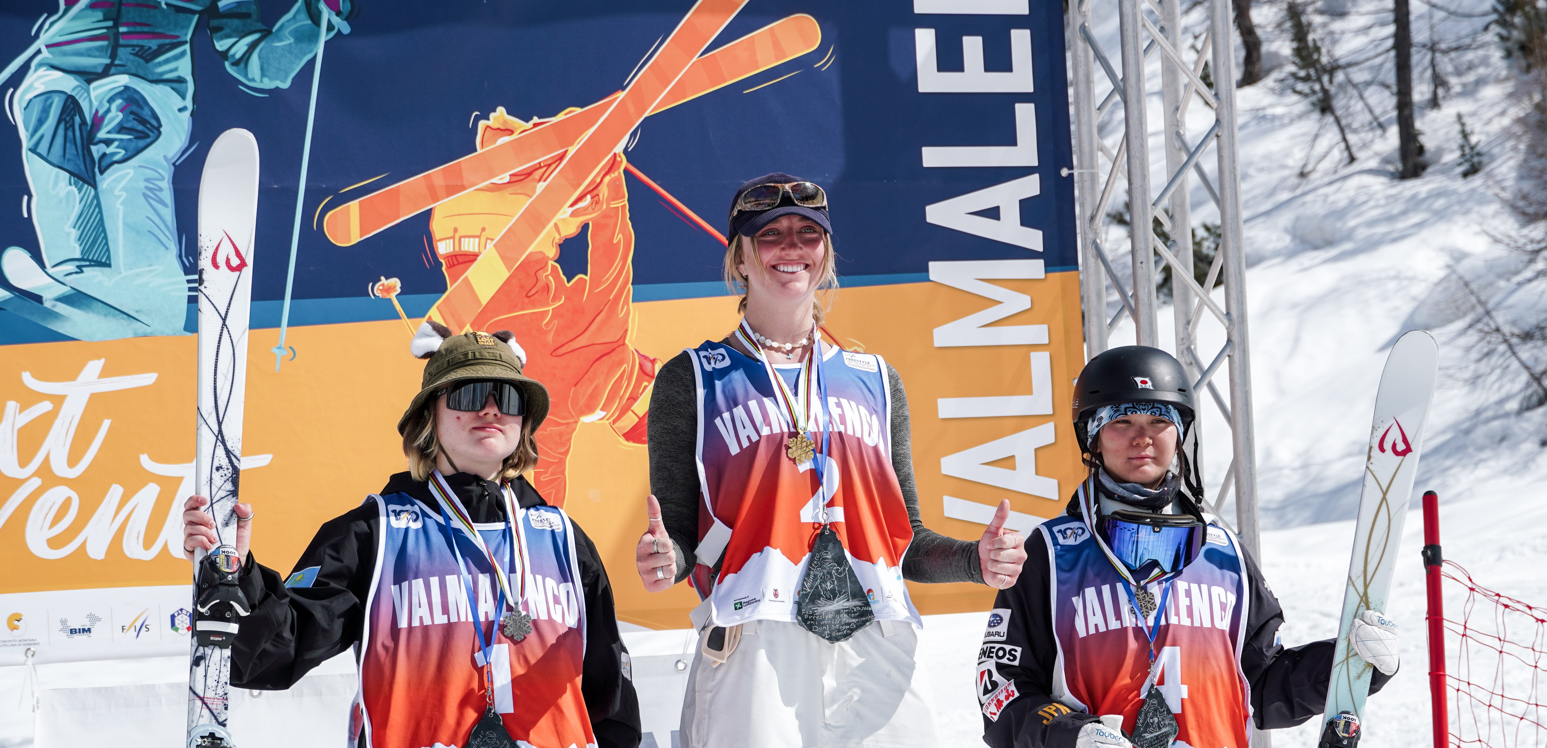Kylie Kariotis smiles on the top box after winning the dual moguls Junior World Championship podium in Valmalenco, Italy