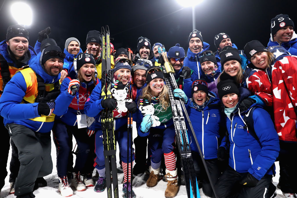 Gold medalists Kikkan Randall and Jessica Diggins celebrate with coaches and teammates at Alpensia Cross-Country Centre. (Getty Images - Lars Baron)