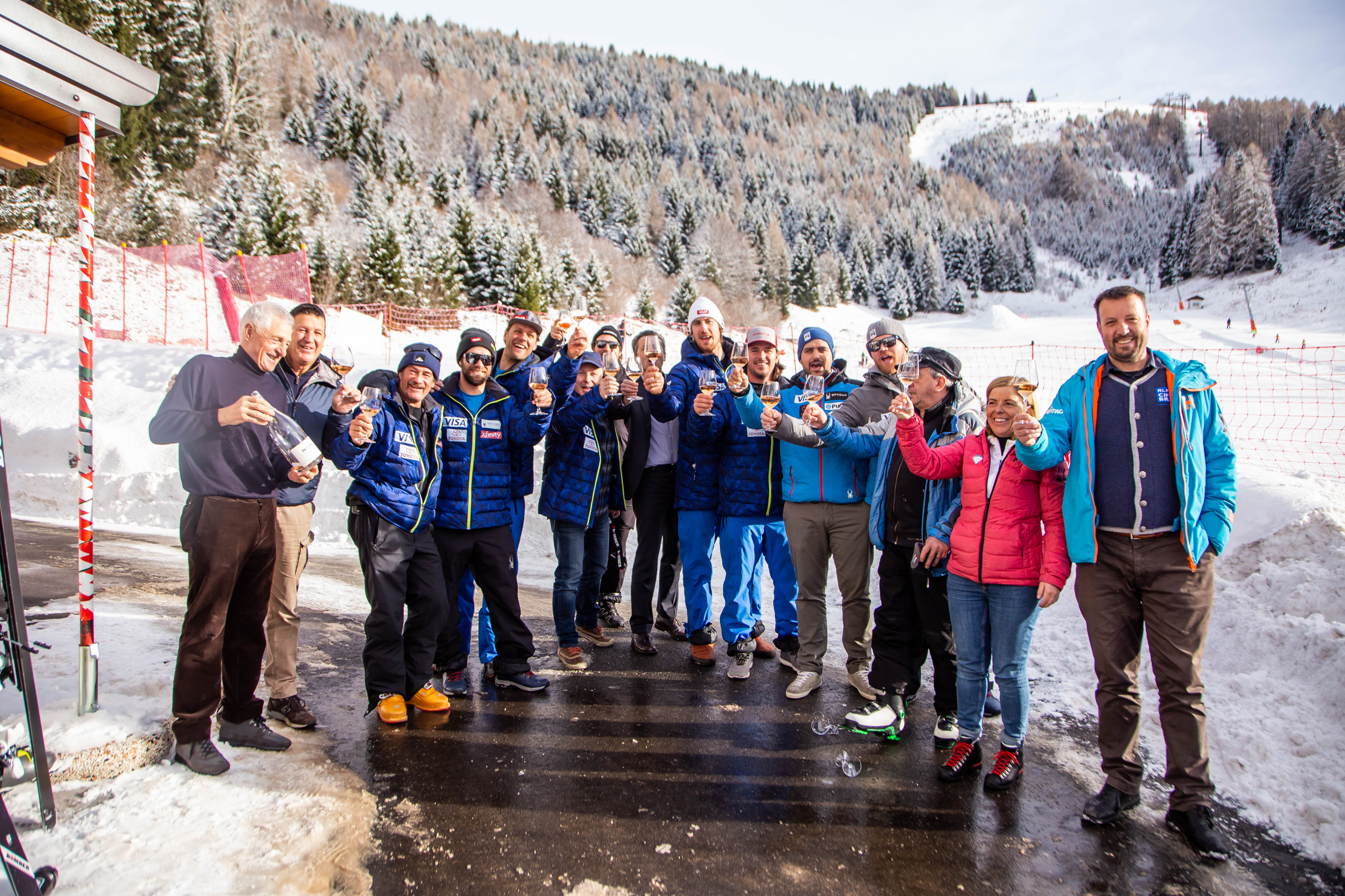 The men's alpine speed team celebrates the partnership with a toast.