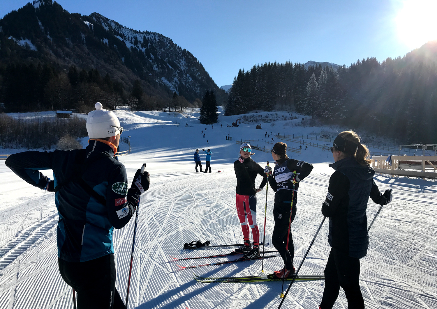 Davis U.S. Cross Country Head Coach Chris Grover (left) talks with Rosie Brennan, Julia Kern, and Alayna Sonnesyn Wednesday during training in Oberstdorf, Germany.  (U.S. Ski &amp; Snowboard - Tom Horrocks)