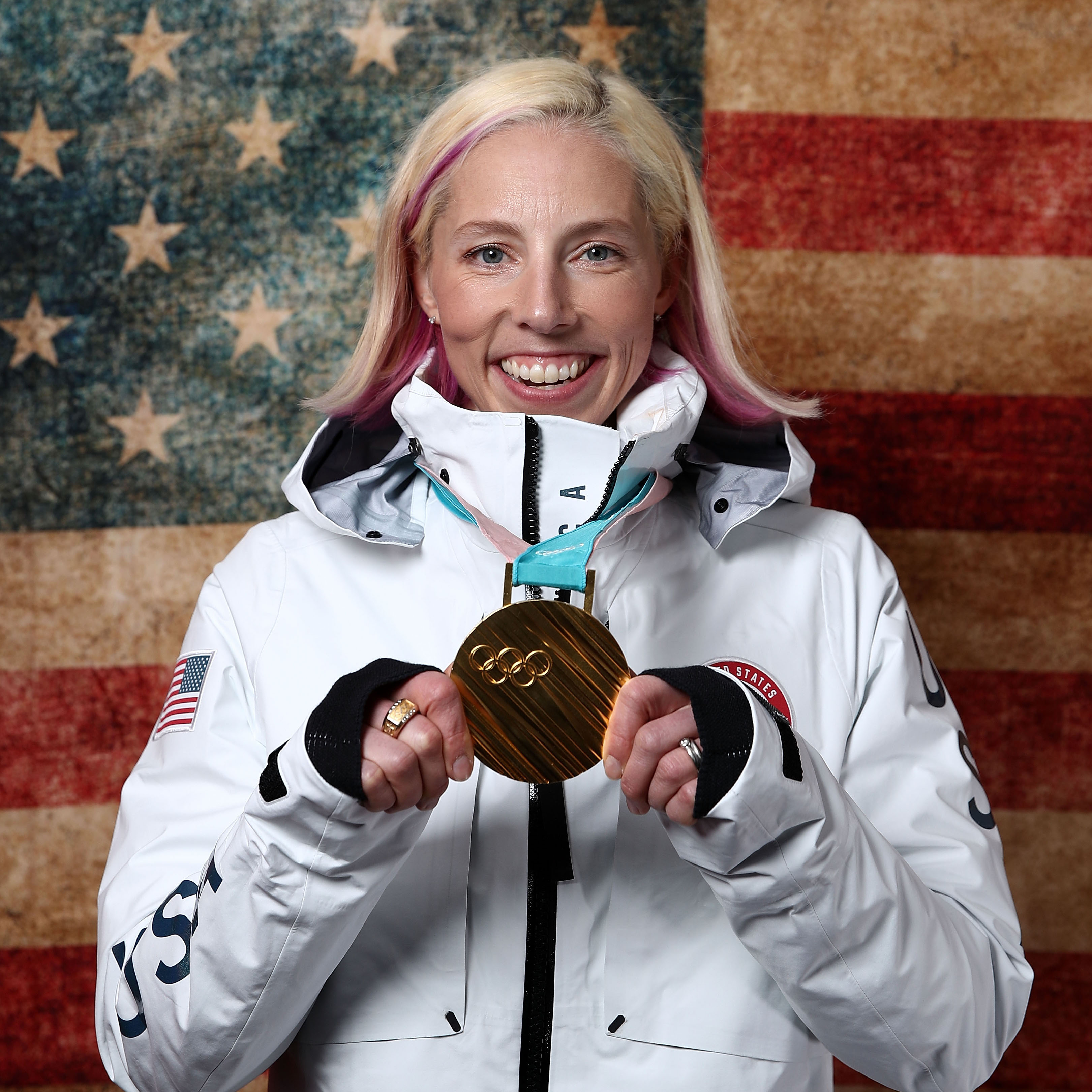 Kikkan Randall smiles with her Olympic gold medal