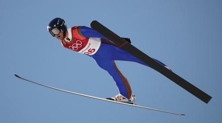 Competing in his final Olympic event, Bryan Fletcher led his young teammates in the large hill team event Thursday. (Getty Images - Clive Mason)